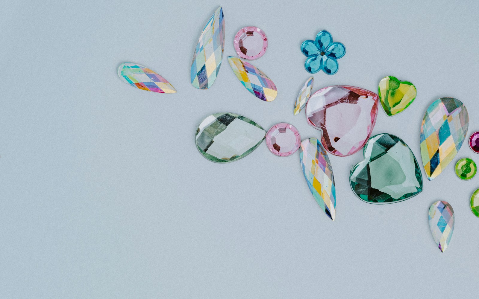 a group of different colored stones on a white surface